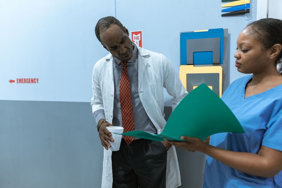 emergency department physician reviewing patient charts