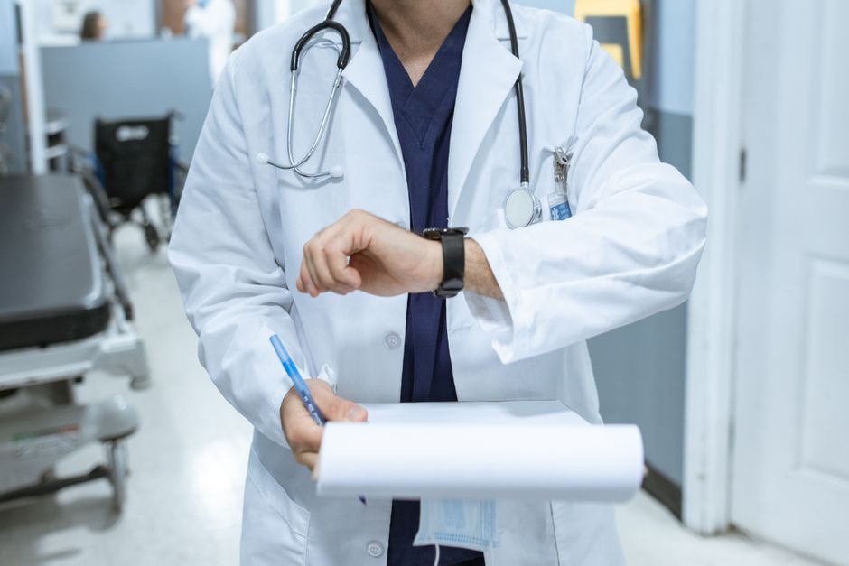 emergency physician reviewing a patient chart at a hospital workstation