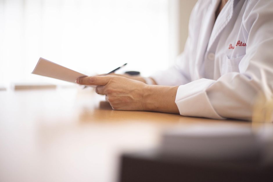 emergency physician reviewing medical records at a hospital workstation